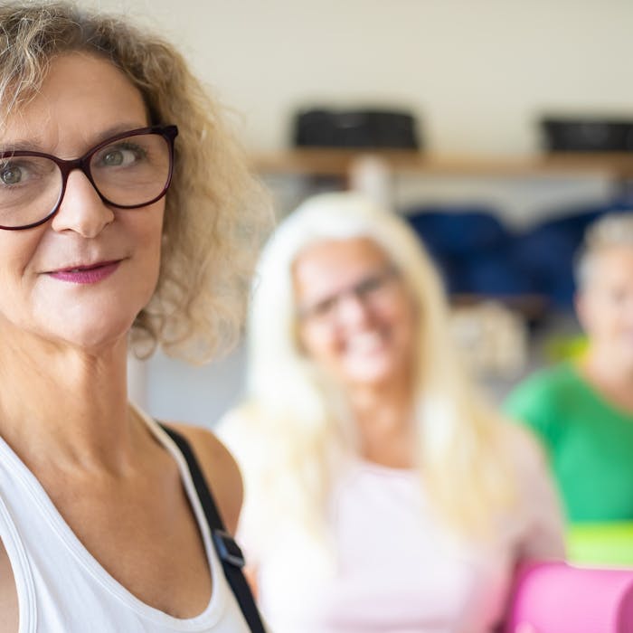 Group of active senior women in yoga class