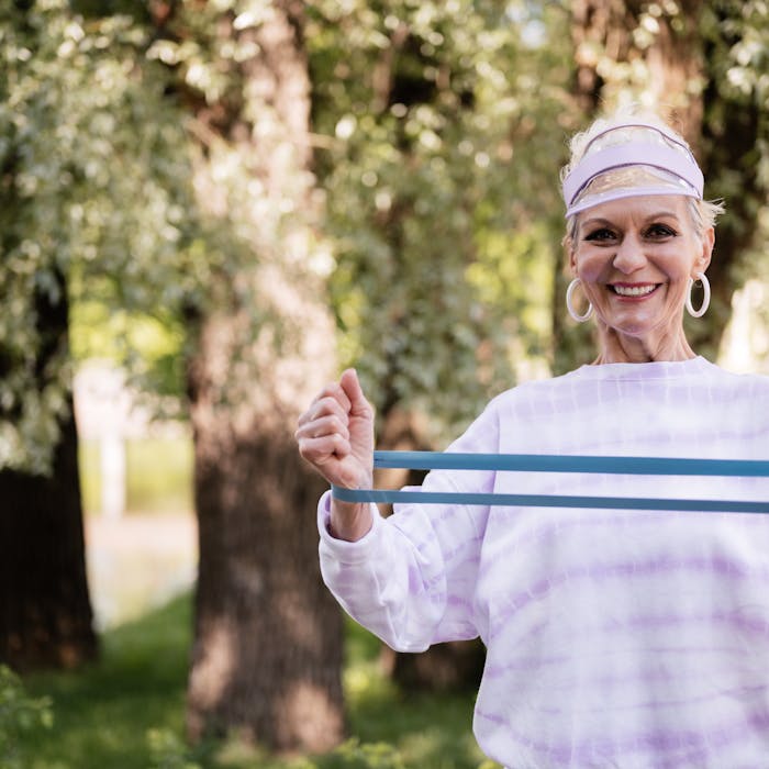 Senior woman resistance training outdoors