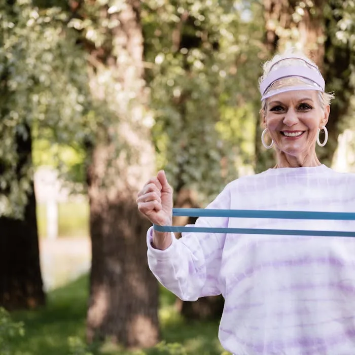 Senior woman resistance training outdoors